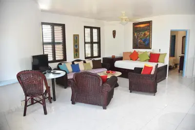 a living room with a couch and chairs and a table at Cabarete Palm Beach Condos in Cabarete
