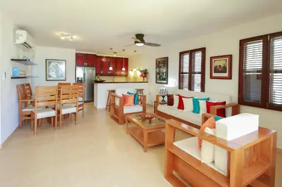 a living room with a couch and a dining room at Cabarete Palm Beach Condos in Cabarete