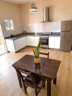 a kitchen with a wooden table with a plant on it at Gipsy Ranch Rooms in Cabarete