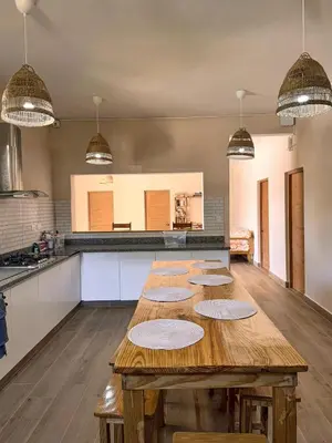 a kitchen with a wooden table with plates on it at Gipsy Ranch Rooms in Cabarete