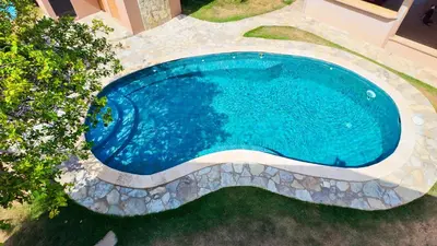 an overhead view of a swimming pool in a yard at Gipsy Ranch Rooms in Cabarete