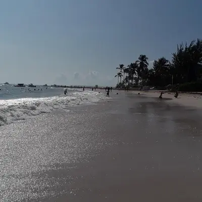 a group of people walking on the beach at Villa Florencia Vip in Punta Cana