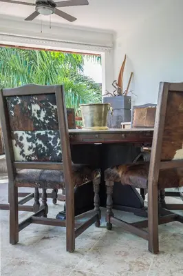 a wooden table with two chairs and a bowl on top at Balcones Beach Penthouse in Las Terrenas