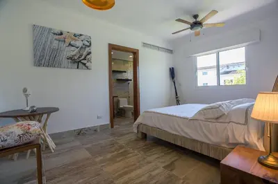 a bedroom with a bed and a ceiling fan at Balcones Beach Penthouse in Las Terrenas