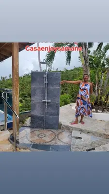 a woman in a dress standing on a beach at casaenjoysamana in Los Naranjos