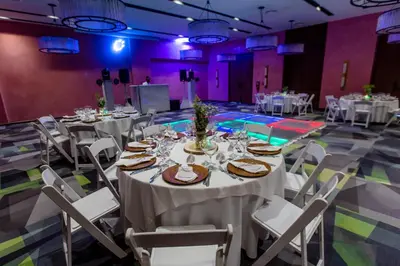 a group of tables and chairs in a room at Tropical Deluxe Princess - All Inclusive in Punta Cana
