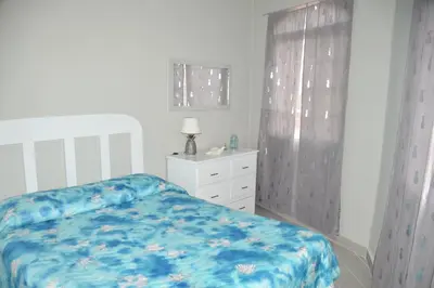 a bedroom with a bed and a dresser and a window at Caribe Apartament S&D el castillo dominicus Apartamento #9 in Bayahibe