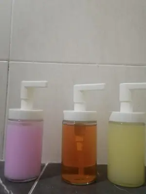 three jars of different colored liquids sitting on a counter at J. B Apartamentos in Santo Domingo