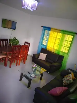a living room with a couch and a table at Oasis de paz in Jarabacoa