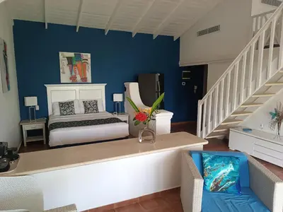 a bedroom with a bed and a blue wall at BUNGALOW 3111 OCEAN VIEW in Las Galeras