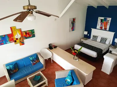 an aerial view of a bedroom with a bed and a couch at BUNGALOW 3111 OCEAN VIEW in Las Galeras