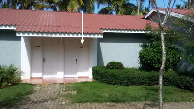 a house with a white door and a red roof at BUNGALOW 3111 OCEAN VIEW in Las Galeras