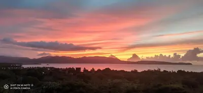 a sunset over a body of water with mountains at BUNGALOW 3111 OCEAN VIEW in Las Galeras