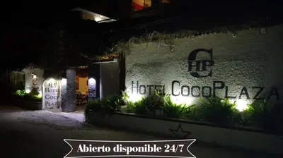 a sign on the side of a building at night at Hotel Coco Plaza in Las Terrenas