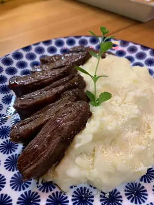 a plate of food with sausage and mashed potatoes at Campito Loving in Higuey