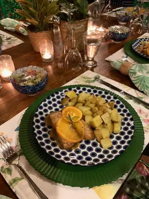 a plate of food on a table with an orange on it at Campito Loving in Higuey