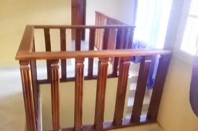a wooden stair case with a wooden railing at Elegant Villa in Nagua with Private Pool and Jacuzzi in Nagua
