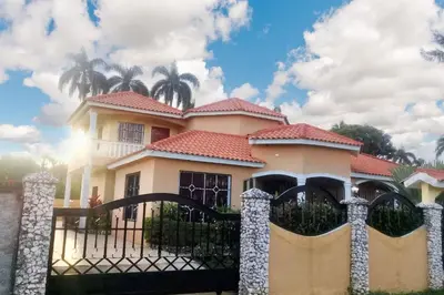 a house with a gate in front of it at Elegant Villa in Nagua with Private Pool and Jacuzzi in Nagua