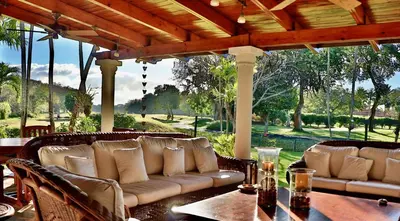 a patio with a couch and a table and chairs at CASA NOSTRA RESORT by Klabhouse in La Romana