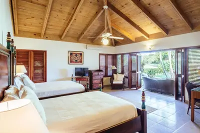 a bedroom with two beds and a desk at CASA NOSTRA RESORT by Klabhouse in La Romana