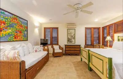 a bedroom with two beds and a living room at CASA NOSTRA RESORT by Klabhouse in La Romana