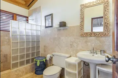 a bathroom with a toilet and a sink and a mirror at CASA NOSTRA RESORT by Klabhouse in La Romana