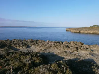 a large body of water with a rocky shore at Guesthouse Villa La Isla in La Romana