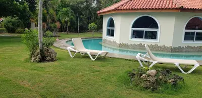 two chairs and a house with a swimming pool at Villas for Vacation 32-18-6 in Sosúa