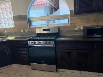 a kitchen with a stove and a sink and a window at Villas for Vacation 32-18-6 in Sosúa
