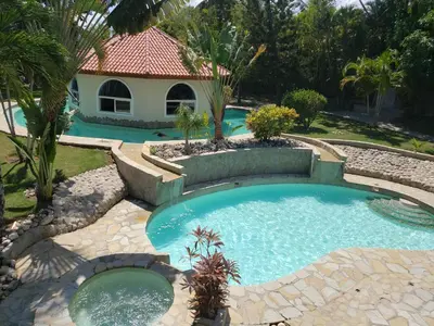 a swimming pool in a yard with a house at Villas for Vacation 32-18-6 in Sosúa