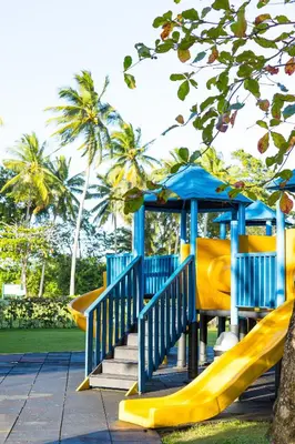 a playground with a yellow slide and a blue structure at Blue JackTar in San Felipe de Puerto Plata