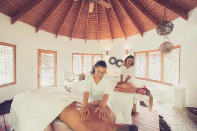 two women sitting on beds in a massage room at Sublime Samana in Las Terrenas