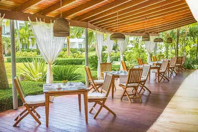 a row of tables and chairs in a restaurant at Sublime Samana in Las Terrenas