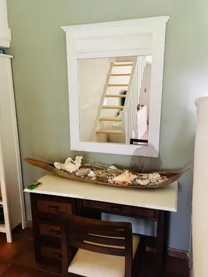 a mirror on top of a desk with a chair at bungalow 3116 vue sur piscine in Las Galeras