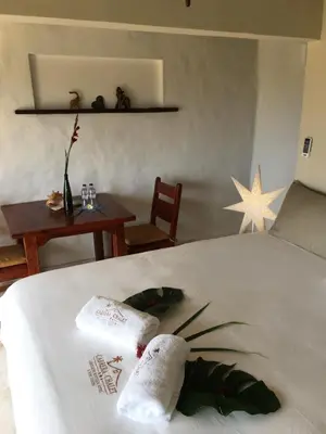 a bedroom with a bed with two towels on it at Cabrera Chalet boutique hotel in Cabrera