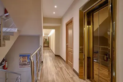 a hallway with a staircase and a glass door at Hotel Riazor in Santo Domingo