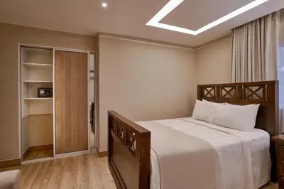 a bedroom with a large bed and a closet at Hotel Riazor in Santo Domingo