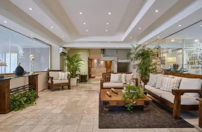 a living room with couches and a table at Hotel Riazor in Santo Domingo
