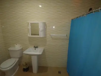 a bathroom with a toilet and a sink at Hotel Riparbella in Santo Domingo