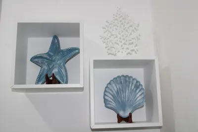 two white boxes with a blue starfish and a glass holder at Apartamento B6 El Dorado en Bávaro - Punta Cana in Punta Cana