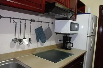 a kitchen with a sink and a microwave at Apartamento B6 El Dorado en Bávaro - Punta Cana in Punta Cana