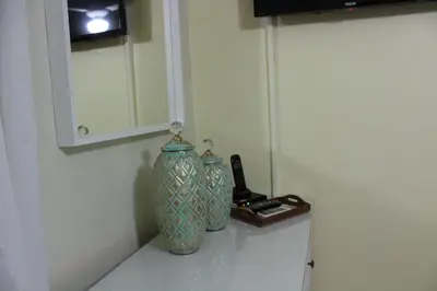 two vases sitting on a counter next to a mirror at Apartamento B6 El Dorado en Bávaro - Punta Cana in Punta Cana