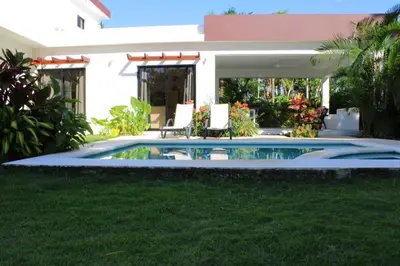 a swimming pool in front of a house at Villa Luce in Las Terrenas