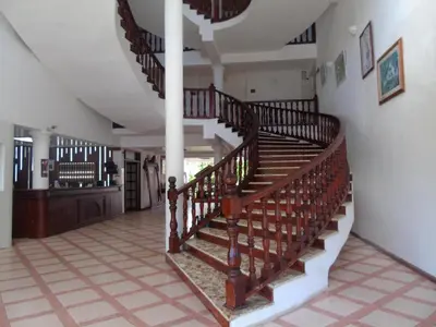 a spiral staircase in a house with aoyer at Piergiorgio Palace Hotel in Sosúa