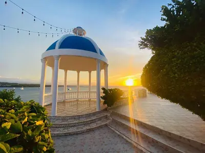a gazebo with a sunset in the background at Piergiorgio Palace Hotel in Sosúa