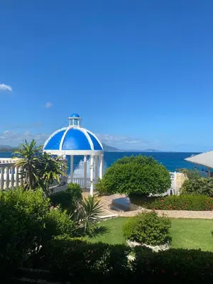 a gazebo with the ocean in the background at Piergiorgio Palace Hotel in Sosúa