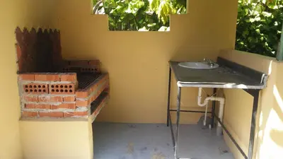 a bathroom with a sink and a brick wall at Los Palmares Guest House & Eventos in San Cristóbal