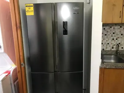 a stainless steel refrigerator in a kitchen next to a sink at lujoso apto con terraza para barbecue in Santiago de los Caballeros