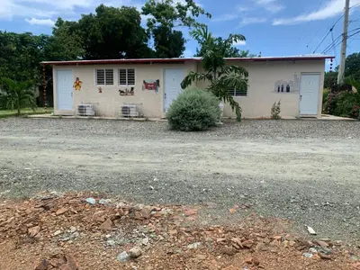 a white building with two white doors on it at Hotel Anedi in Concepción de La Vega