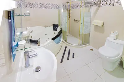 a bathroom with a tub and a toilet and a sink at Hotel La Casona Dorada in Santo Domingo